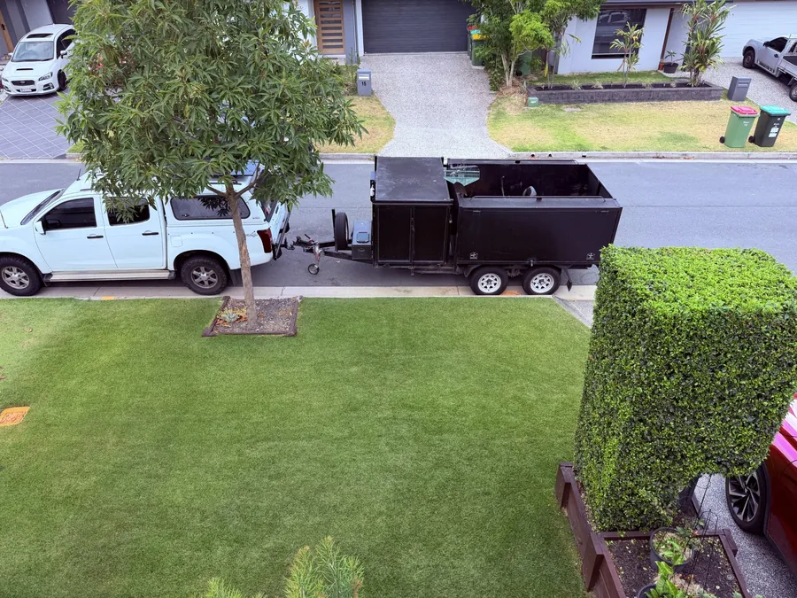 Lawn and box hedge kept sharp, ute and trailer on site — scheduled grounds maintenance Gold Coast