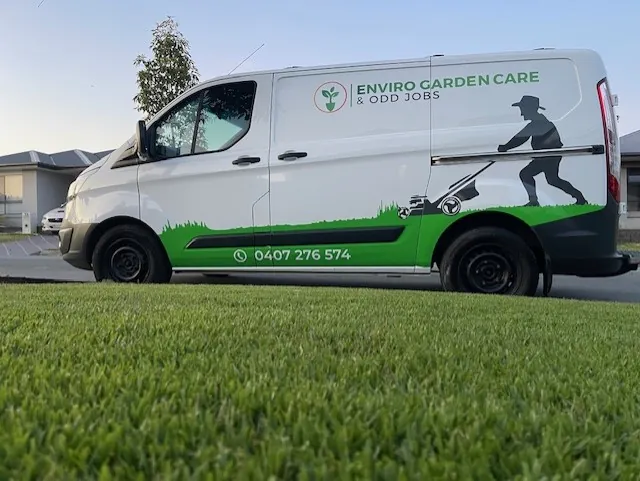 Branded van parked over a freshly mown verge — commercial lawn care Gold Coast